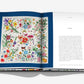An open book, "Gucci: The Art of Silk" by Assouline, features a vibrant floral illustration on the left page inspired by Gucci silk scarves and the word "Flora" as a title on the right page.