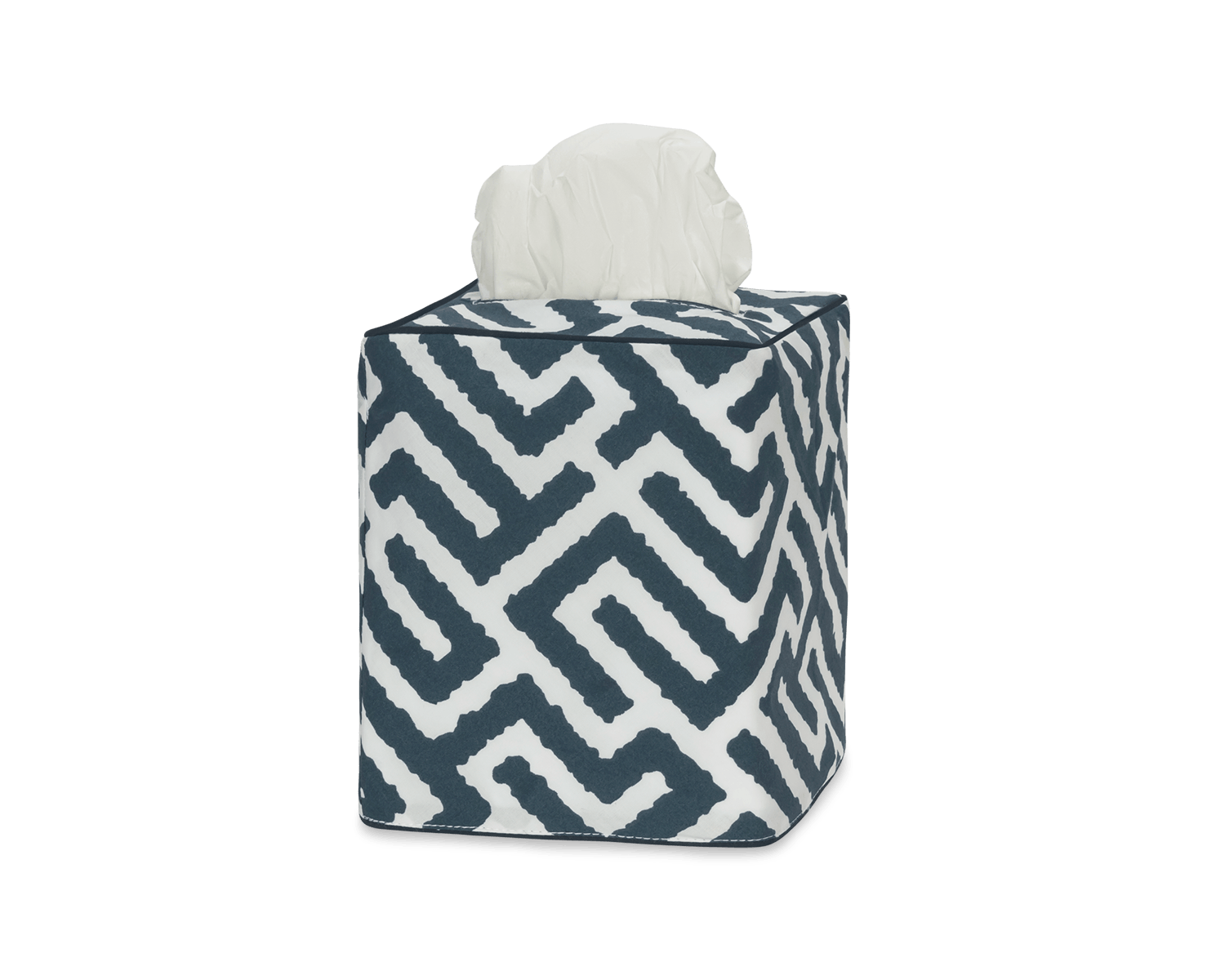 Elevate your bathroom decor with the Matouk Gabriel Tissue Box Cover Collection, featuring a stylish geometric navy and white Schumacher print with a tissue partially pulled out from the top.