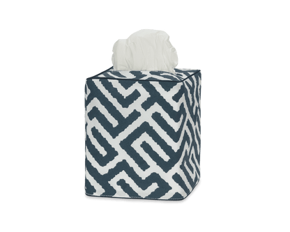 Elevate your bathroom decor with the Matouk Gabriel Tissue Box Cover Collection, featuring a stylish geometric navy and white Schumacher print with a tissue partially pulled out from the top.