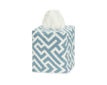 The Gabriel Tissue Box Cover Collection by Matouk features a blue and white geometric design, adding style to any bathroom. One tissue is shown protruding from the top.