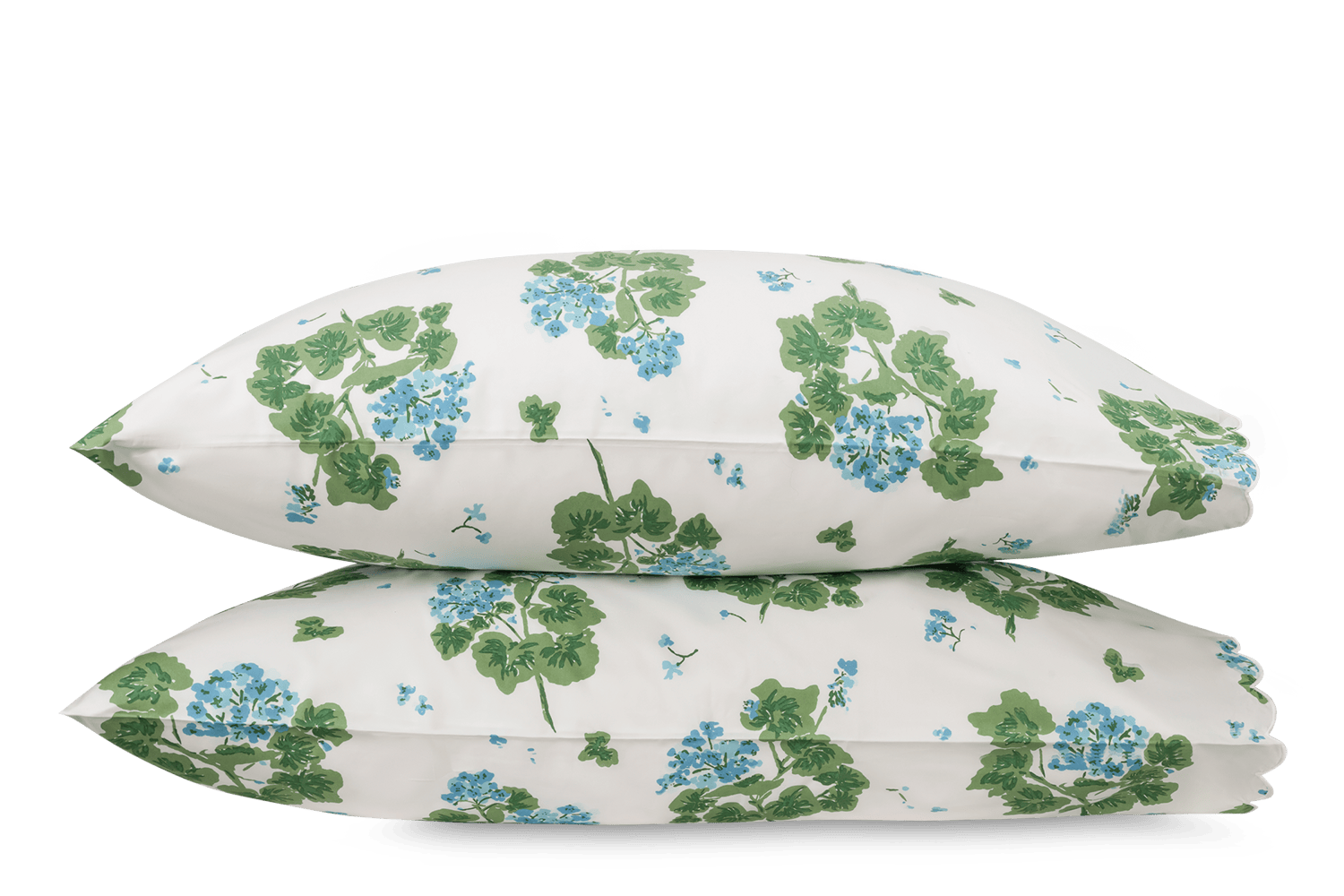 Two white pillowcases from the Matouk Tillett x Matouk Geranium Bedding Collection in blue, featuring a green and blue floral print, are stacked together against a plain background.