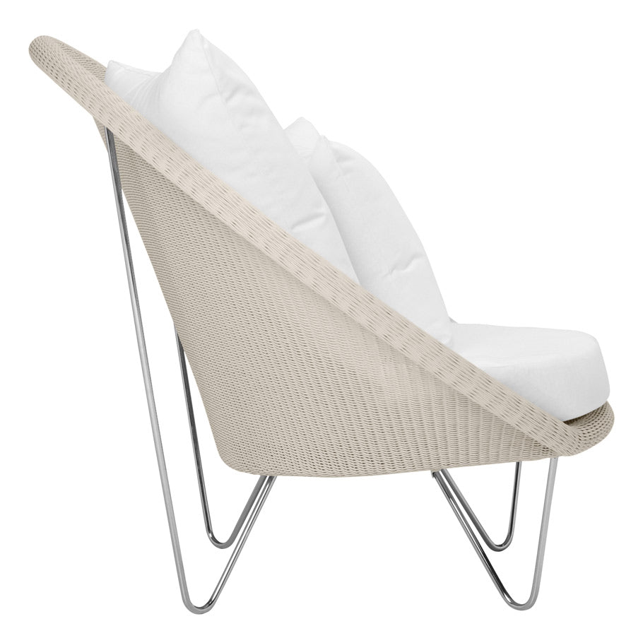 The Janus et Cie Lounge Chair in Schooner Snow features a beige handwoven stainless steel frame, white cushions, and angled metal legs—a modern profile perfect for any luxury space.