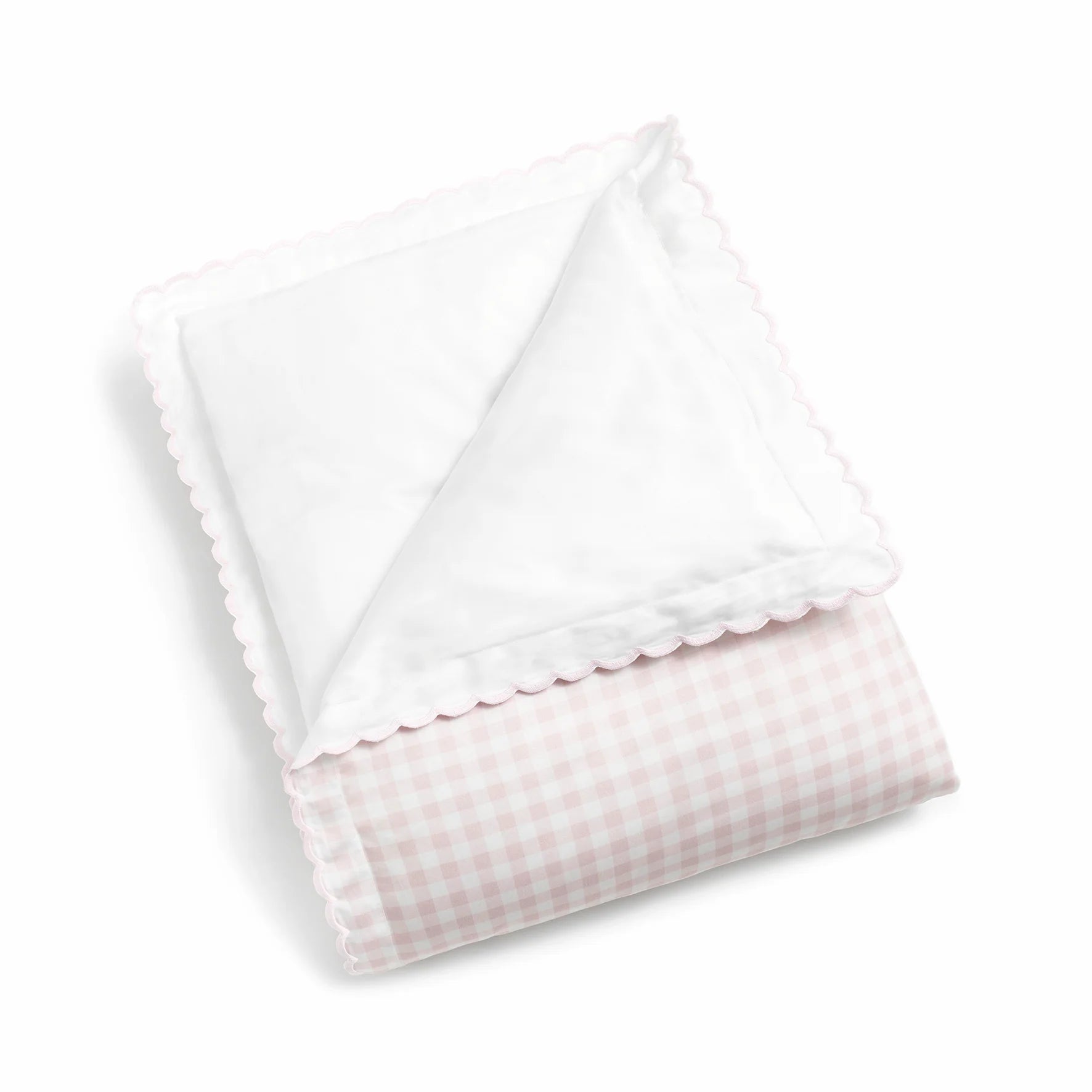 The Gooselings Pink Picnic Gingham Bedding is a folded, breathable baby blanket with pink gingham on one side, plain white on the other, and scalloped edges. Made from pure materials and shown on a white background.
