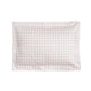 The Gooselings Pink Picnic Gingham Bedding is a rectangular pillow with a pink and white gingham check pattern and scalloped edges, made from pure materials for breathable baby bedding, shown against a white background.