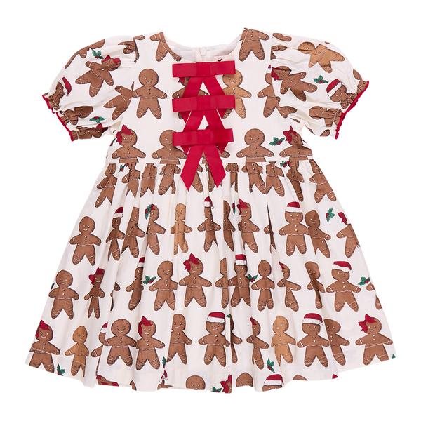 The Pink Chicken Girls Hermione Dress is a delightful gown featuring gingerbread men, accented with red bows and holly designs. Perfect for holiday gatherings, this dress embodies the festive spirit with elegance and whimsy.