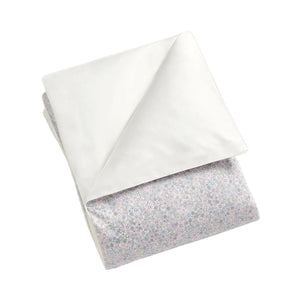 The Gooselings Enchanted Wildflowers Bedding Collection features a folded OEKO-TEX certified baby blanket made from pure materials, with one side plain white and the other adorned in a light floral pattern for breathable, safe bedding.