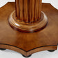 Close-up of the base of the Gottlieb Side Table by Bunny Williams, featuring reeded vertical grooves on its pedestal and an octagonal wooden platform in a rich mahogany finish.