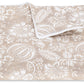 Experience the Granada Bedding Collection by Matouk—a beige and white folded blanket adorned with a botanical block print featuring delicate leaves, flowers, and subtle pomegranate motifs inspired by classic textile design.