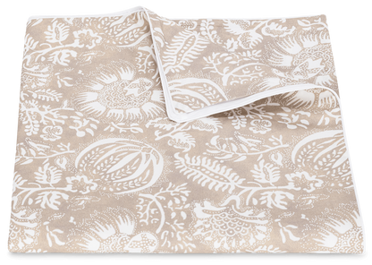 A beige cotton percale fabric featuring a white floral and leaf pattern, displayed on a plain background from the Matouk Granada Bedding Collection in Dune.