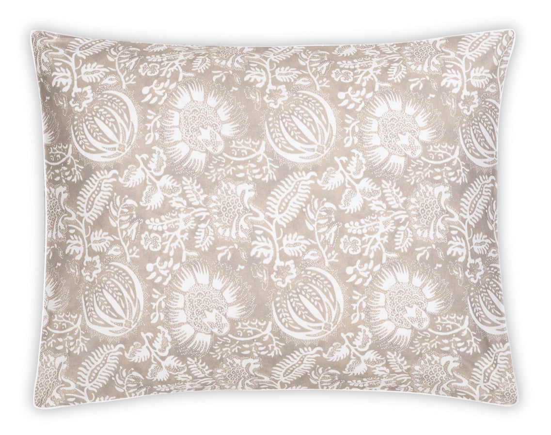Introduce elegance to your space with the Granada Bedding Collection by Matouk. This rectangular pillow features a beige background accented by a white floral pattern, inspired by classic block print textiles, with various flowers and leaves arranged evenly across the surface.