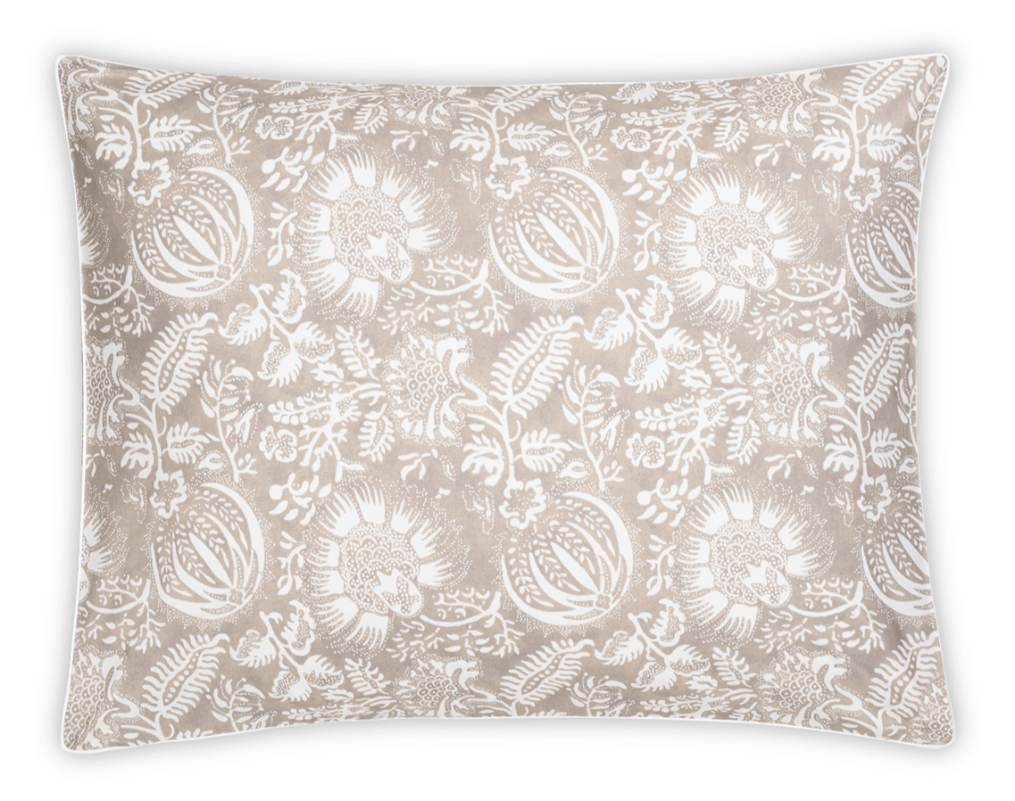 The Granada Bedding Collection, Dune by Matouk features a rectangular pillow with a beige and white floral pattern on a black background, crafted from soft cotton percale and inspired by traditional block print textiles.