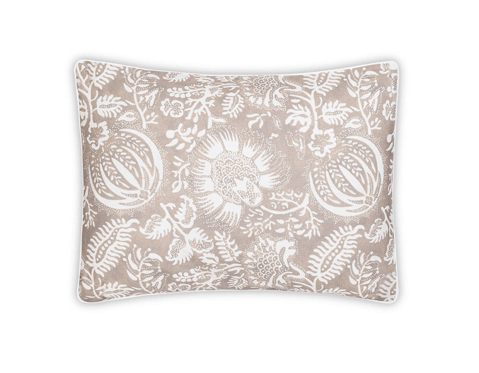 The Matouk Granada Bedding Collection in Dune features a rectangular beige cotton percale pillow with a white floral and botanical block print motif, shown on a white background.