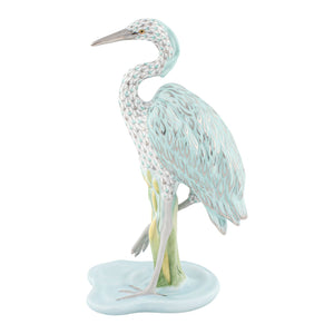 The Herend Reserve Collection Great Blue Heron is a limited edition porcelain figurine with detailed soft blue and white feathers, elegantly posed on a pale blue base.