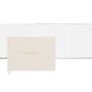 The Sugar Paper Flax Guest Book features premium linen book cloth with "GUESTS" embossed in gold, shown closed and open to blank pages—ideal for capturing memories.