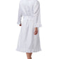 A person in the Haute Home Ruffle Robe, made from 100% white cotton sateen with ruffled cuffs and hem, stands barefoot and is seen from the back against a white background.