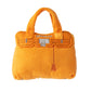The Haute Diggity Dog Barkin Bag Squeaker Dog Toy is a chic orange plush shaped like a handbag with “BARKIN” embroidery, stitched handles, and clasp—perfect for your stylish pup!.