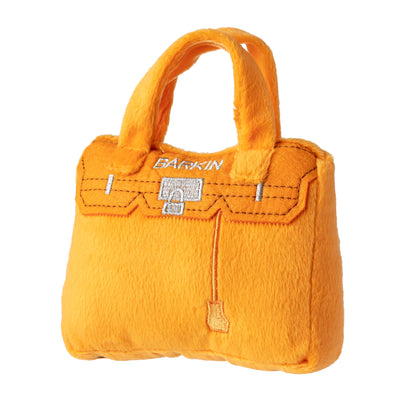 The Barkin Bag Squeaker Dog Toy by Haute Diggity Dog is an orange handbag-shaped plush with “BARKIN” embroidered on the front—the perfect squeaky toy for your stylish pup.