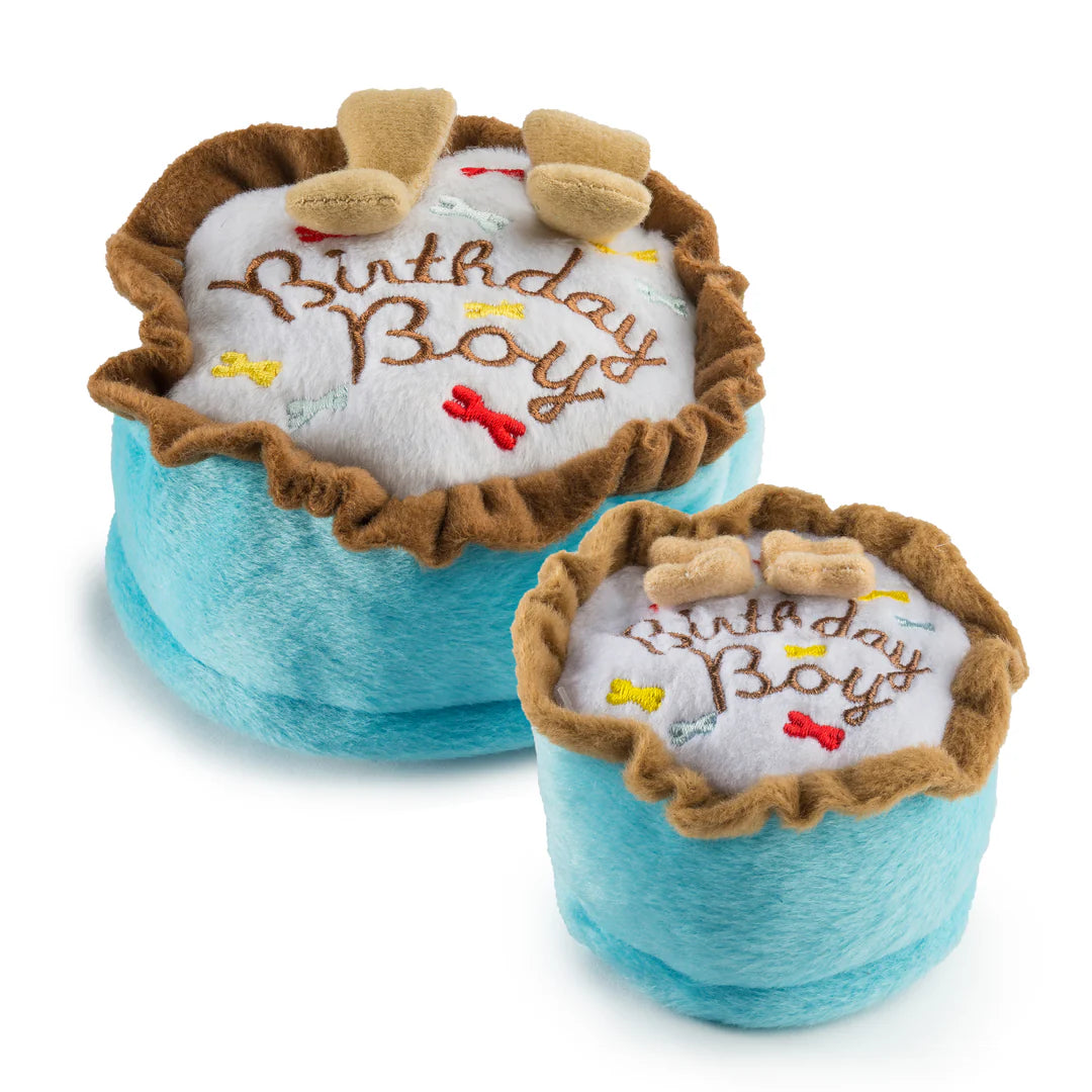 The Haute Diggity Dog Birthday Boy Toy is a plush dog birthday cake with blue sides, brown trim, "Birthday Boy" embroidery, bone decorations, two plush bones, and a squeaker inside. Includes 2 toys shaped like cakes for extra fun.