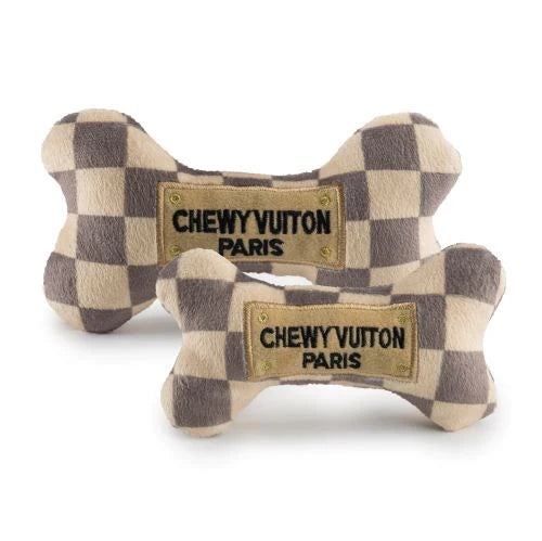The Haute Diggity Dog Checker Chewy Vuiton Bone is a plush squeaky dog toy with a chic checkered pattern and "Chewy Vuiton Paris" label—perfect for pampered pups who love stylish playtime.