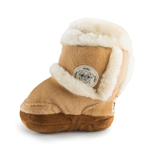 The Haute Diggity Dog Pugg Boot Toy is a tan boot-shaped plush with white faux fur trim, a cartoon pug patch, and a squeaker inside for hours of fun.