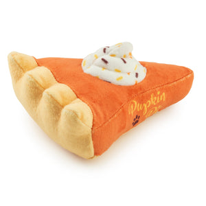 The Haute Diggity Dog Pupkin Pie Slice Dog Toy is a plush pumpkin pie-shaped toy with whipped cream and sprinkles, featuring an internal squeaker for extra fun playtime.