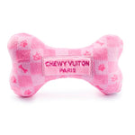 The Pink Checker Chewy Vuiton Bone by Haute Diggity Dog is a plush, bone-shaped squeaky toy with a chic checkered pattern and "Chewy Vuiton Paris" embroidery.