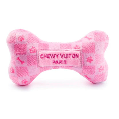 The Pink Checker Chewy Vuiton Bone by Haute Diggity Dog is a plush, bone-shaped squeaky toy with a chic checkered pattern and "Chewy Vuiton Paris" embroidery.