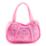 The Pink Chewy Vuiton Handbag by Haute Diggity Dog is a plush, squeaky dog toy featuring a checkered design, paw prints, bones, and a "Chewy Vuiton Paris" label—a chic accessory for your pup.