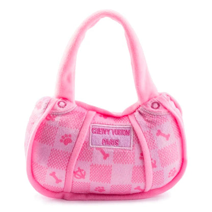 The Pink Chewy Vuiton Handbag by Haute Diggity Dog is a plush, squeaky dog toy featuring a checkered design, paw prints, bones, and a "Chewy Vuiton Paris" label—a chic accessory for your pup.