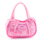 The Pink Chewy Vuiton Handbag by Haute Diggity Dog is a small, pink plush dog toy with checkered pattern, paw prints, and bones. The front label reads "CHEWY VUITON PARIS.