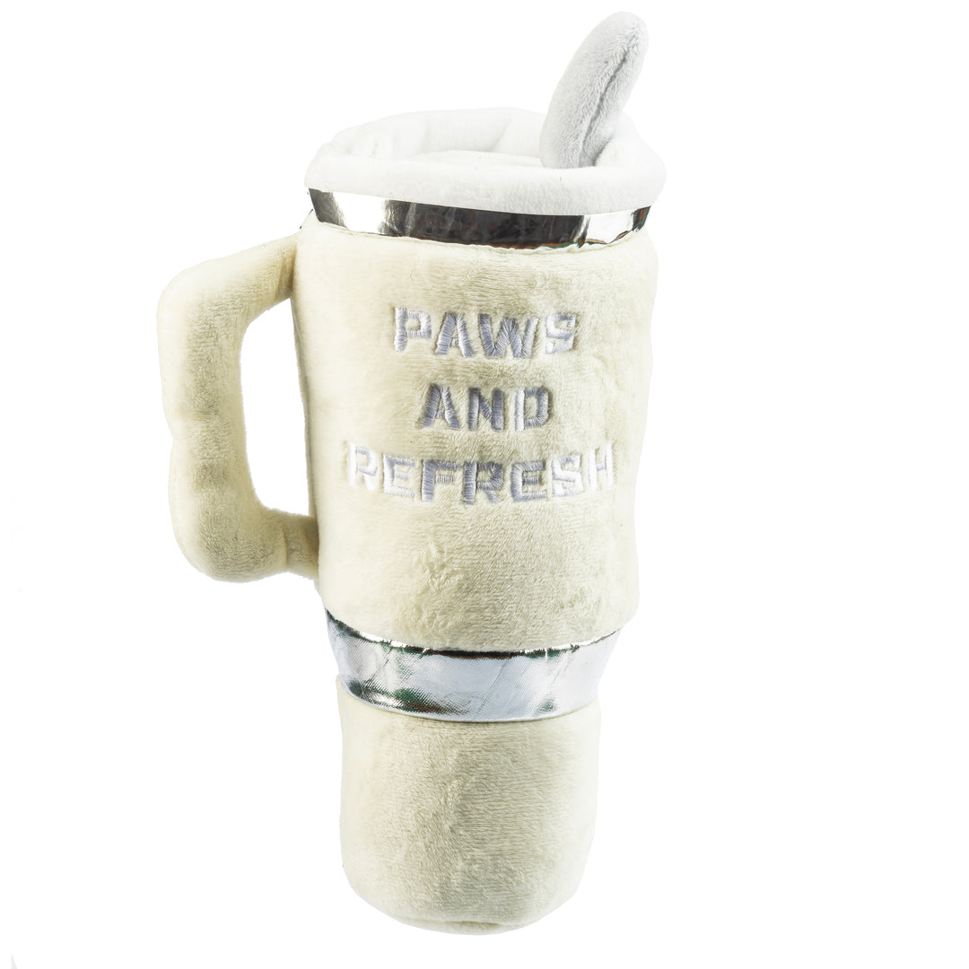 The Snuggly Pup Plush Toy by Haute Diggity Dog is an ivory dog toy shaped like a coffee cup with a handle and a toy straw, featuring "PAWS AND REFRESH" embroidered on the front—a cute tumbler toy for your pup.