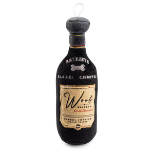 The Woof Reserve Cabarknet Dog Toy by Haute Diggity Dog is a plush, squeaky wine bottle-shaped toy with playful dog-themed labels—ideal for dogs who enjoy both fun and cuddles.