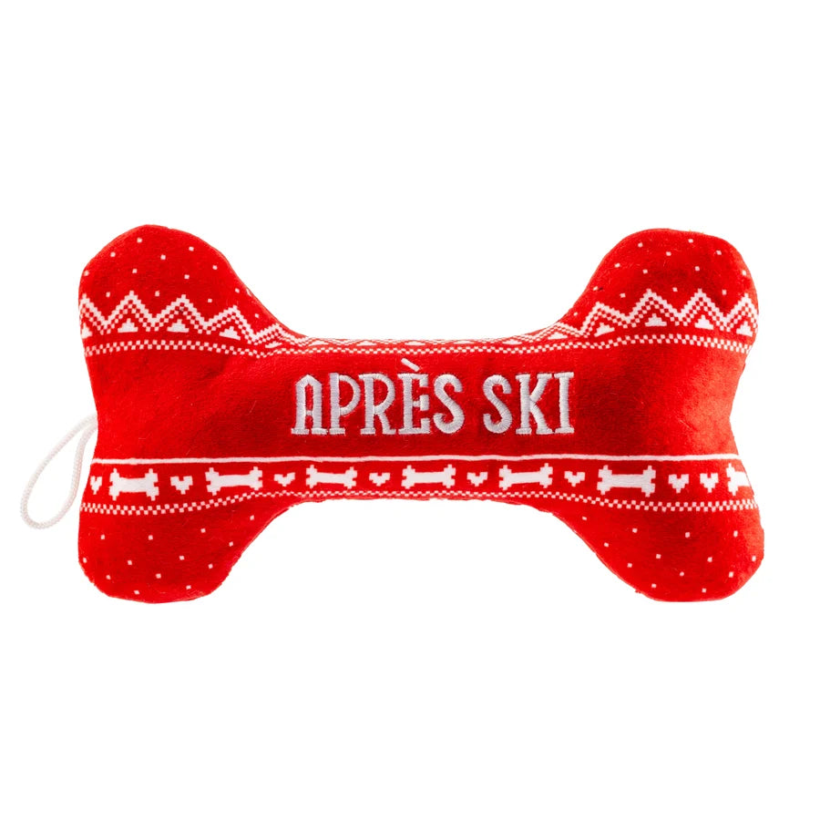 Introducing the Haute Diggity Dog Apres Ski Collection: a red plush dog bone toy featuring playful white patterns and “APRÈS SKI” embroidered at the center. Perfect for pups who love ski-themed toys, this festive chew toy brings fun to playtime both on and off the slopes.