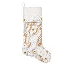 Kim Seybert Gilt Wave stocking featuring white fabric decorated with swirling gold and silver beaded patterns and scattered clear gems.