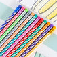 A row of vibrant, diagonally striped Hester & Cook Colored Pencils, each topped with a metallic ferrule and eraser.