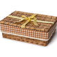 The Chic Gift Hamper by Sharland England features a rectangular wicker basket with brown and white gingham trim, lid, and yellow ribbon—ideal for presenting artisanal gifts like hand-poured candles or sustainable soap.