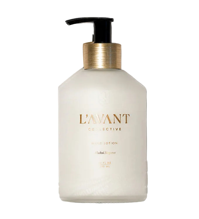 A bottle from L'Avant Collective's Blushed Bergamot Scent Collection, featuring a black pump and gold accents, sits elegantly on a white background.