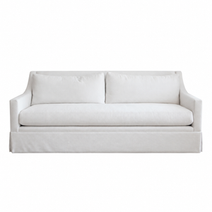 The Hannah Condo Sofa in Nit Witty Sea Salt by Verellen is a three-seat white sofa featuring straight arms, a tailored skirt, and two back cushions in a Sea Salt finish, shown against a plain white background. This compact design combines style and comfort, making it ideal for modern living spaces.