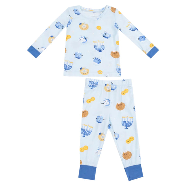 The Angel Dear Hanukkah L/S Loungewear Set, from the brand Angel Dear, is a light blue children's pajama set made from soft viscose from bamboo and spandex, featuring blue cuffs. It showcases playful designs of menorahs, dreidels, lions, and coins. Enjoy easy care with machine washing on a gentle cycle for long-lasting comfort and fun.