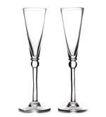 Two clear Hartland Champagne Flute glasses by Simon Pearce stand side by side on a white background—a perfect handmade gift set for an elegant wedding.