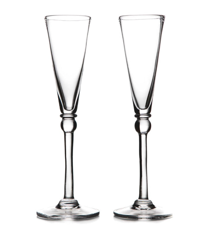Two clear Hartland Champagne Flute glasses by Simon Pearce stand side by side on a white background—a perfect handmade gift set for an elegant wedding.