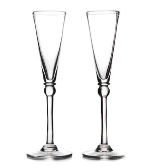 Two clear Hartland Champagne Flute glasses by Simon Pearce stand side by side on a white background—a perfect handmade gift set for an elegant wedding.