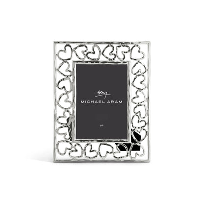The Michael Aram Heart Frame features a hand-forged look with interlocking heart shapes as a symbol of love, and displays a 4x6 inch "Michael Aram" placeholder card.