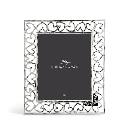 The Michael Aram Heart Frame Collection features a silver border of interlocking hearts that celebrate love, and displays a card with the brand name "Michael Aram.