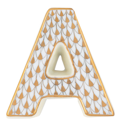 The Herend Letters collection features a ceramic letter "A" with a white base, gold border, and a repeating pattern of gold and grey teardrops, showcasing artistic detail often found in hand painted designs.