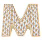 The Herend Letters ceramic "M" features a white base with hand-painted gold teardrop patterns outlined in gold, ideal for artistic appreciation.