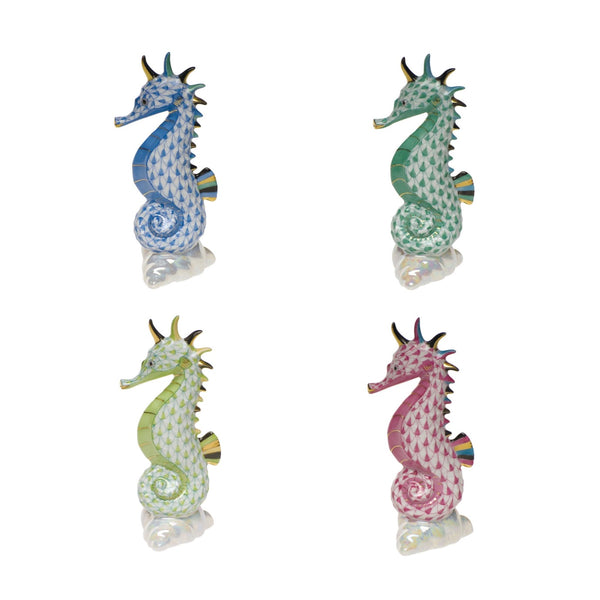 Four Herend Sea Horse figurines by Herend—blue, green, yellow, and pink—feature shimmering hand-painted designs and textured patterns, arranged in a 2x2 grid on white for artistic appeal.