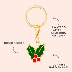 Foggy Dog’s Holly Collar Charm is a gold keychain with a double-sided holly and red berry design, made from durable hard enamel. Includes a split ring and clasp—perfect as a festive pet or holiday collar accessory.