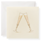 The Karen Adams Just Married Gift Enclosures feature two champagne flutes with gold bubbles clinking on a natural white square card, hand-glittered for a festive touch, paired with a matching white envelope.