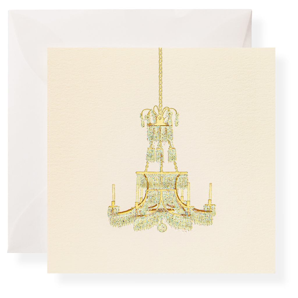 The Karen Adams Dolce Vita Gift Enclosures feature an illustration of a gold and crystal chandelier on a cream-colored square card, paired with a white envelope.